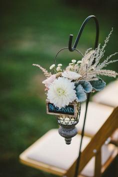 
                    
                        Hang floral arrangements from decorative hooks staked into the grass | Brides.com
                    
                