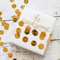 
                    
                        Turn plain white gift wrapping paper into something spectacular with just a little bit of golden garland and a sticker.
                    
                